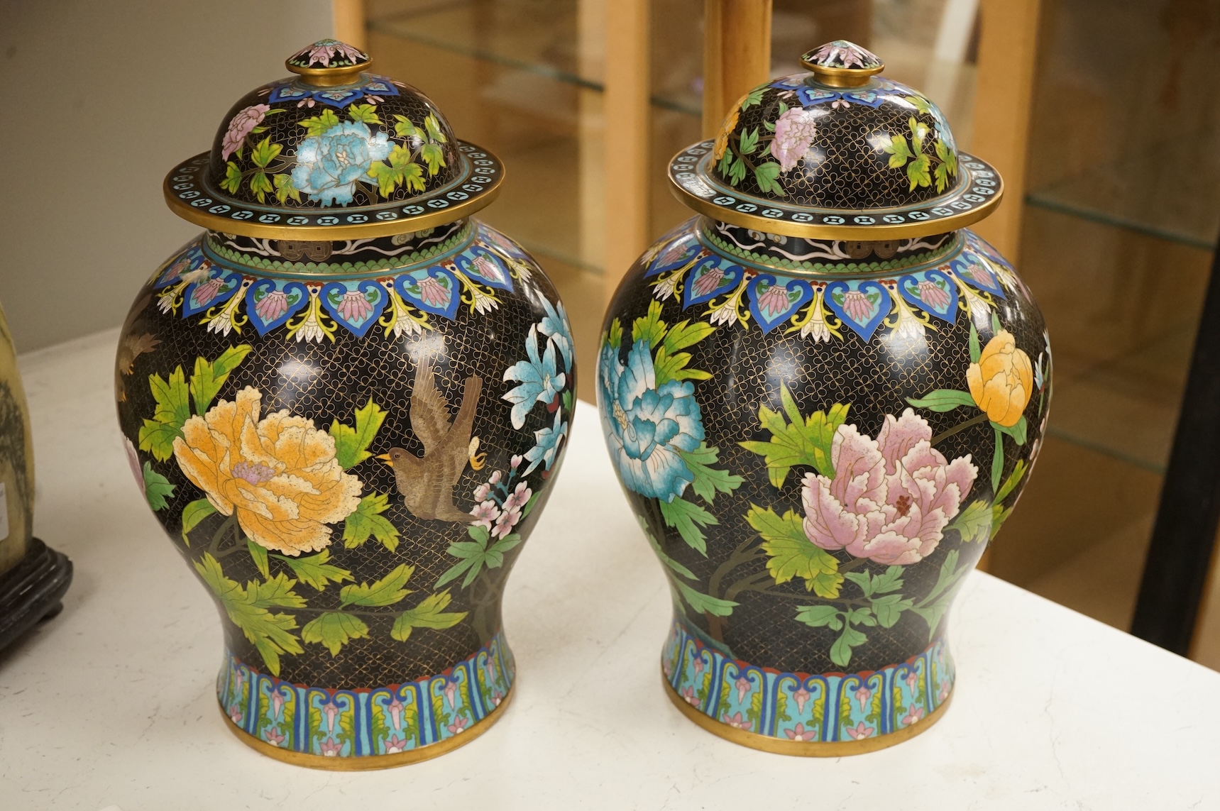 A pair of Chinese cloisonné baluster jars and covers decorated with birds and flowers, 38cm high